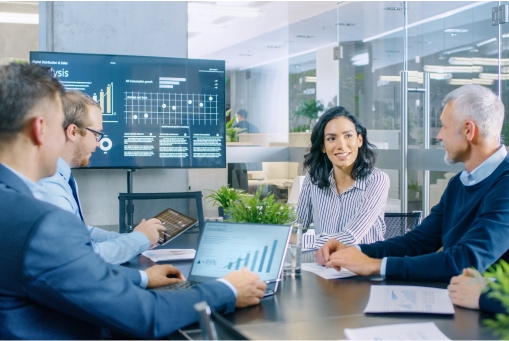 Colleagues in a meeting room using audiovisual equipment