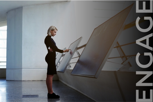 visitor accessing wayfinding information Visitor using wayfinding information interactive digital screens