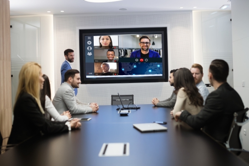 hybrid working colleagues video conferencing Hybrid working - colleagues talking to remote workers in a video conference