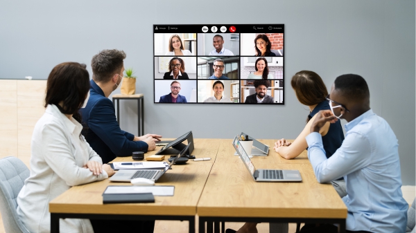 Colleagues in a meeting room on a video conference call