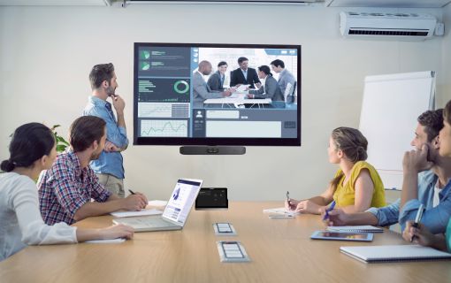 Team in a hybrid meeting. Video conferencing.
