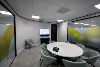 Large meeting room at the Openwork Partnership with video conferencing and Yamaha ADECIA ceiling panels.