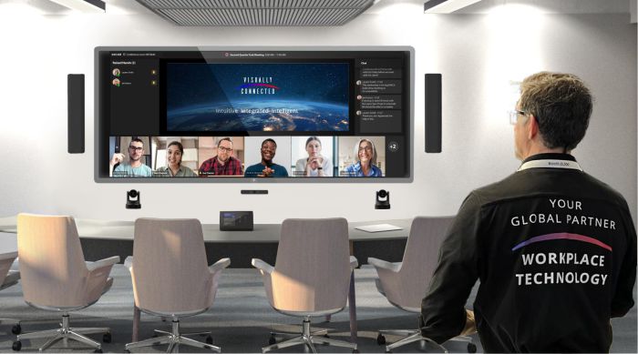 A Visually connected technician looks in to a Signature Microsoft Teams Rooms.