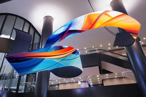Flexible LED screen suspended from a lobby ceiling.
