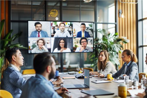 colleagues on a video conference in a large contemporary boardroom