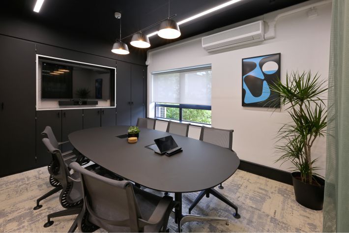 Concept4 case study image 2 Modern meeting room with audio visual technology including AirServer for content sharing on a large digital screen.