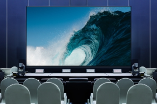 Modern event space with a large display screen.